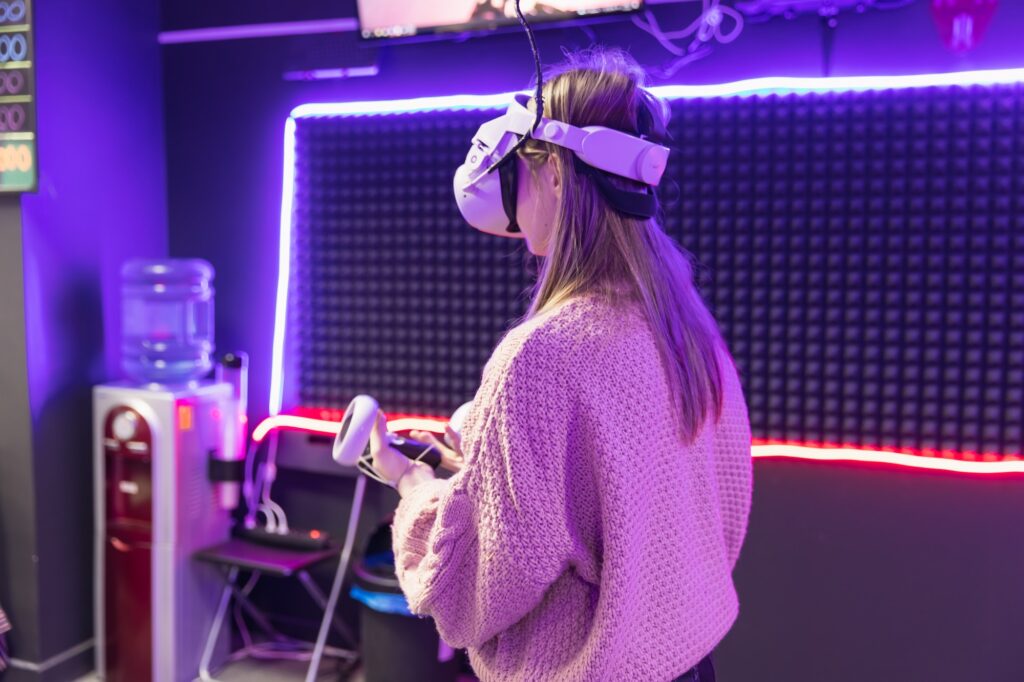 Young woman is playing VR game in glasses. Cyber space and virtual gaming.